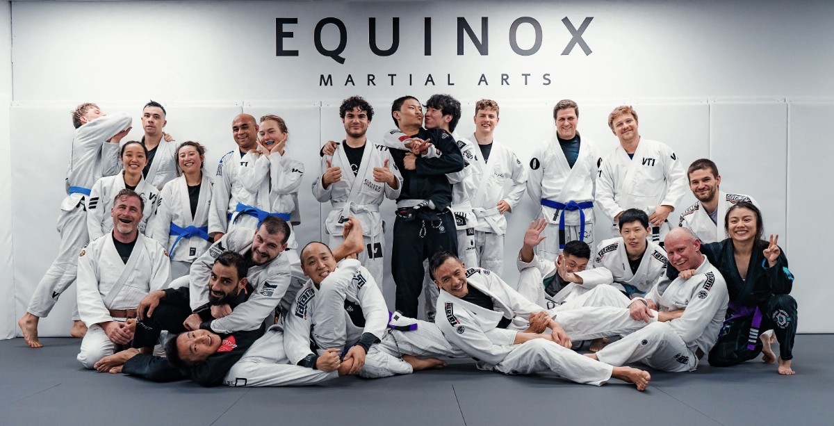 Brazilian Jiu-Jitsu students at Equinox Academy in Chatswood, wearing their gi uniforms and smiling for the camera