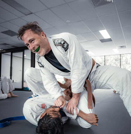Equinox students practissing Brazilian Jiu-Jitsu (BJJ) in traditional gi uniforms