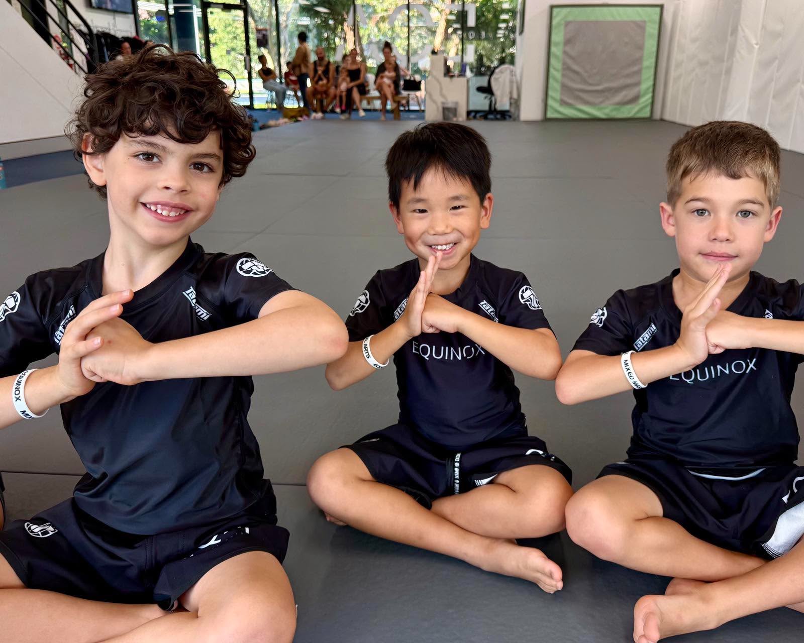 Equinox Academy students doing a traditional martial arts salute